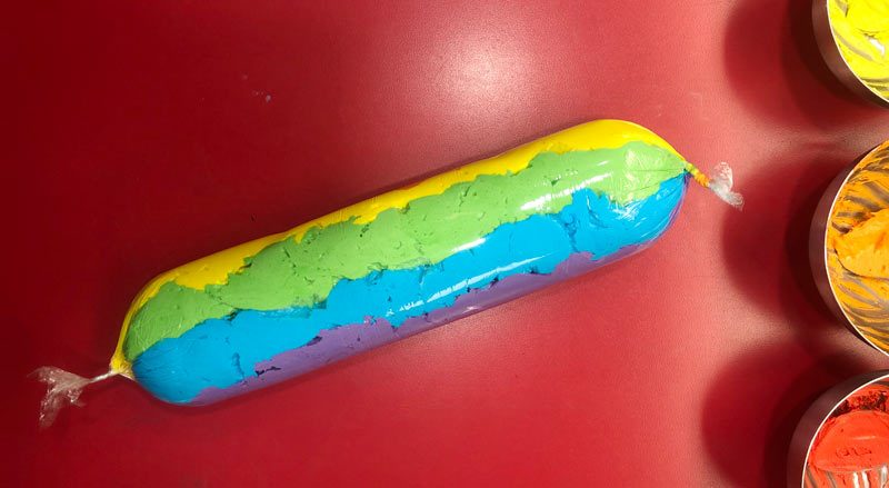 Coloured icing rolled up in Saran Wrap